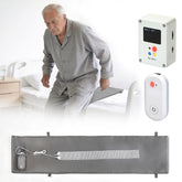 40-inch bed exit and bedwetting alert system with pressure sensor mat, moisture sensor strip, call device, and alarm monitor beside a senior getting out of bed.