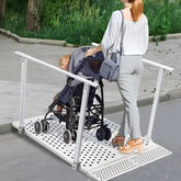 Woman pushing a stroller on a portable ramp outdoors