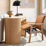 Brown leather power lift chair with wooden frame positioned beside a home desk