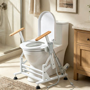Single-motor toilet lift seat with wooden armrests installed over a standard toilet in a home bathroom