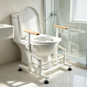 Electric sit-to-stand toilet lift seat with stable support frame and wooden arms beside a walk-in shower