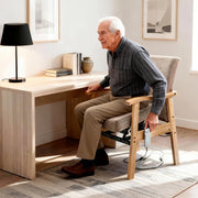 Elderly man using a wooden power lift assist office chair with padded seat and armrests
